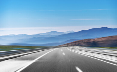 Wall Mural - Mountain highway with blue sky and rocky mountains on a background