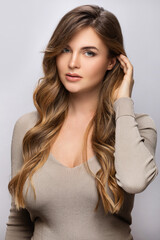 Wall Mural - portrait of young pretty woman with a curly hairstyle