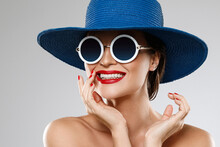 Beautiful Woman Wearing Blue Hat And Sunglasses Is Ready For Vacation
