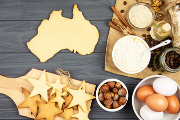 baking cookies in  shape of the continent of australia.  Happy Australia Day message greeting card 