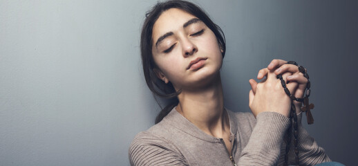 Wall Mural - prayer young woman holding cross