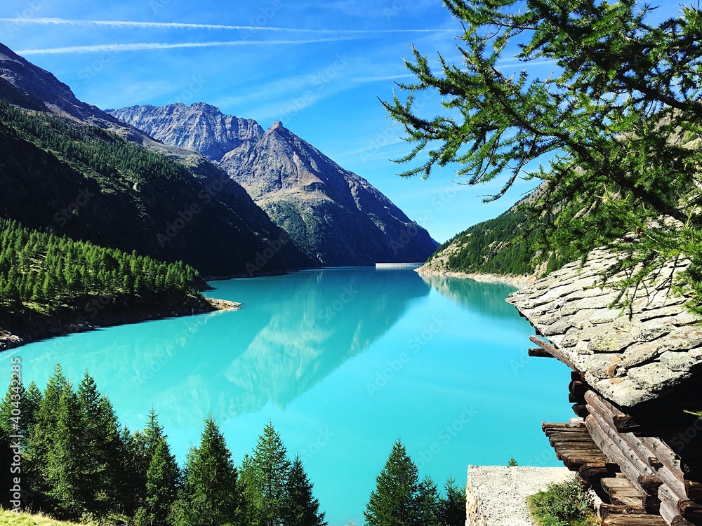 Panoramic View Of Lake And Mountains Against Blue Sky - obrazy, fototapety, plakaty 