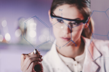 Poster - Portrait of a confident female health care expert in life science laboratory writing structural chemical formula on a glass board. Healthcare and modern life science concept. Blue toned image.