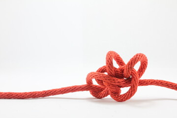 close-up of tangled rope against white background