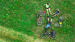 © Iuliia Sokolovska - Family cycling on bikes aerial view from above, happy active parents with child have fun and relax on grass, family sport and fitness on weekend