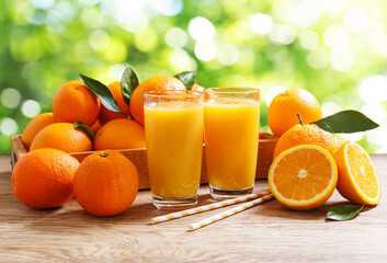 Wall Mural - glasses of fresh orange juice with fresh fruits