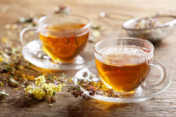 Wall Mural - Cups of herbal tea with dried herbs