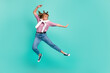 Full size profile side photo of young attractive beautiful serious girl jumping karate isolated on teal col or background