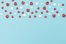 Red White Glitter Hearts On Pastel Blue Paper Background. Valentines Day Concept. Flat Lay, Top View, Copy Space.