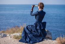Romantic Young Beautiful Lady Looks At Spyglass Seascape. Vintage Style. Steampunk Concept.