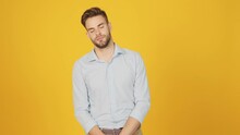A Bored Young Man Is Yawning Standing Isolated Over A Yellow Background In The Studio