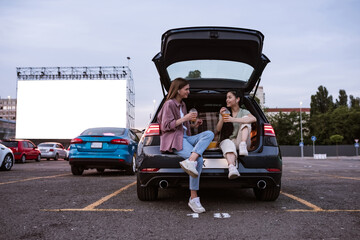 Young multiracial girls at auto cinema parking during session