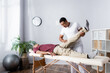 © LIGHTFIELD STUDIOS - african american chiropractor working with middle aged man in modern clinic