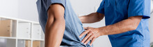 Cropped View Of Mature Chiropractor Working With African American Man, Banner