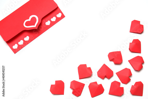 Envelope from red paper with hearts and several handmade 3D red paper hearts on white background isolated. Love, Valentine's, women's day, relations, wedding, romantic template copy space 