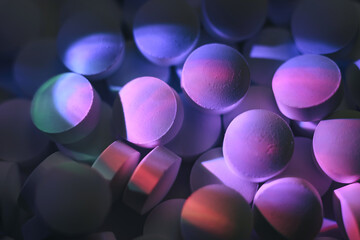 Fototapete - Pills or drugs in a package under neon light. Beautiful background pattern for design.