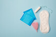 menstruation products, intimate hygiene, women gynecological health, sanitary pads, tampon and menstruation cup on blue background