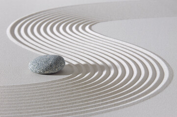 Japanese zen garden with stone in textured sand