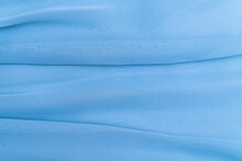 The Texture Of The Fabric In The Folds Of Blue Pastel Color, The Background Of A Luxurious Delicate Fabric