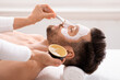 © Prostock-studio - Bearded caucasian man getting face treatment at spa salon