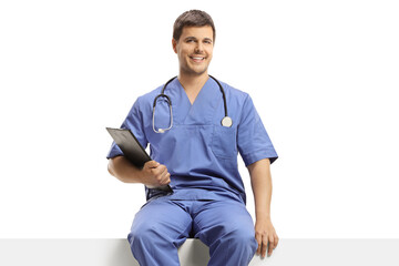 Poster - Doctor in a blue uniform sitting on a white panel