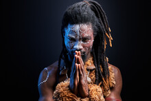 Black Male Model Doing Ritual Isolated Over Black Background, Portrait Of Man In National Wear On Naked Body, Tribal Maya Aborigen, Shaman