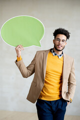 Young businessman in smart casualwear and eyeglasses showing blank speech bubble