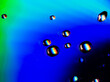 Leinwandbild Motiv Close-up of water drops on a coloured surface