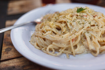 Plato de pasta carbonara con pan al ajo