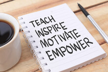 Teach Inspire Motivate Empower, Text Words Typography Written On Paper Against Wooden Background, Life And Business Motivational Inspirational