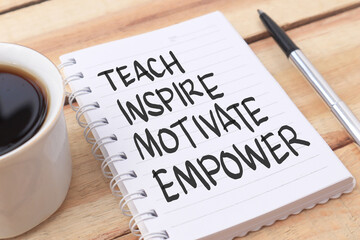 teach inspire motivate empower, text words typography written on paper against wooden background, li