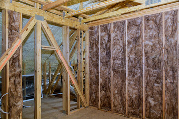 Wall Mural - Insulation in the sloping attic of a new frame house