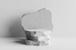 © nawapon - White stone podium, Cosmetic display stand on white background. 3D rendering