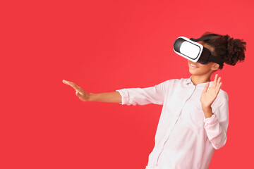 Poster - Teenage African-American girl with virtual reality glasses on color background