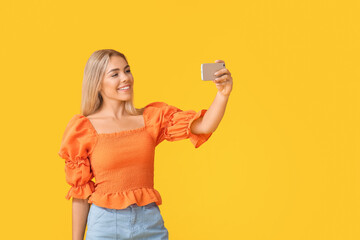 Canvas Print - Teenage girl taking selfie on color background