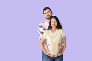 Poster - Young pregnant couple on color background