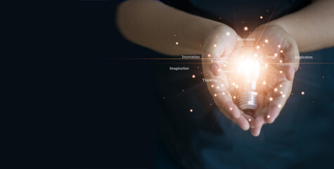 Leinwandbilder - Abstract, Hands holding a light bulb of network, innovation, creativity and inspiration on dark background.