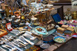 Different antiques on flea market - vintage silver cultery - spoons, knifes, forks and other vintage things. Collectibles memorabilia and garage sale concept