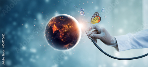Earth at night being with butterfly checked by a doctor with a stethoscope. Environment and pollution. Save the world. Earth day. Energy saving concept.