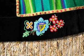 A national and traditional Polish scarf with a folk emblem in the field of harvest straw bales