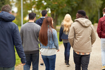 Canvas Print - people, friendship, communication and international concept - group of happy friends walking along autumn park