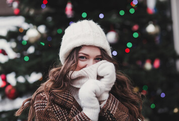 girl in a woolen hat and winter jacket