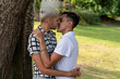 © Spectral-Design - Young gay couple kissing in a public park