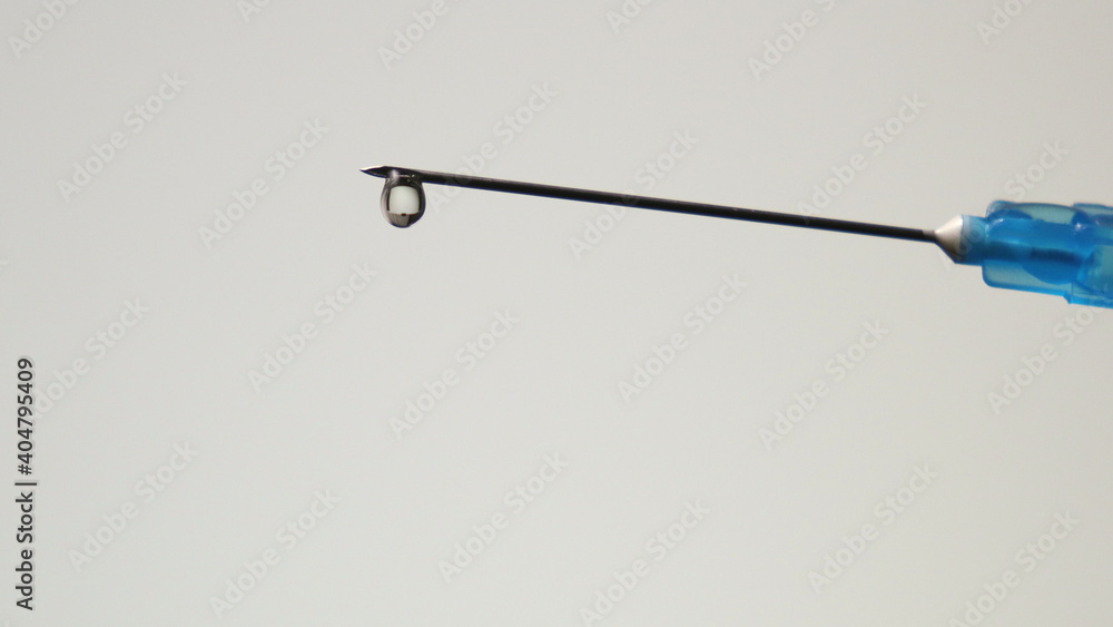 Macro photography of a medical syringe with a drop of injection ...