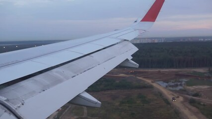 Wall Mural - Landing of the plane. View from the wings of the planet. Travel concept