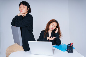 Portrait of two business asian women wearing formal jacket suit working together in office.