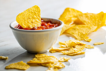 Wall Mural - Tortilla chips and red tomato salsa dip. Mexican nacho chips.