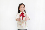 Fototapeta Na ścianę - Little asian child girl give you a gift box on white background. Happy new year and Merry christmas concept. Focus at Gift box