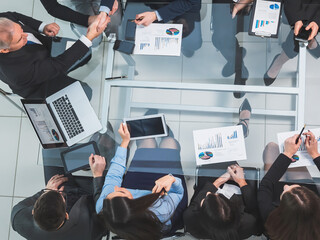 top view. handshake of financial partners at a working meeting.