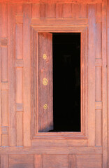 Wall Mural - Open window. Thai style wooden windows on brown wood wall background